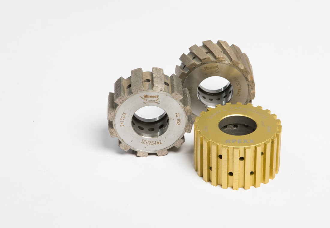 CNC profile wheels stacked on a tool holder for stone fabrication